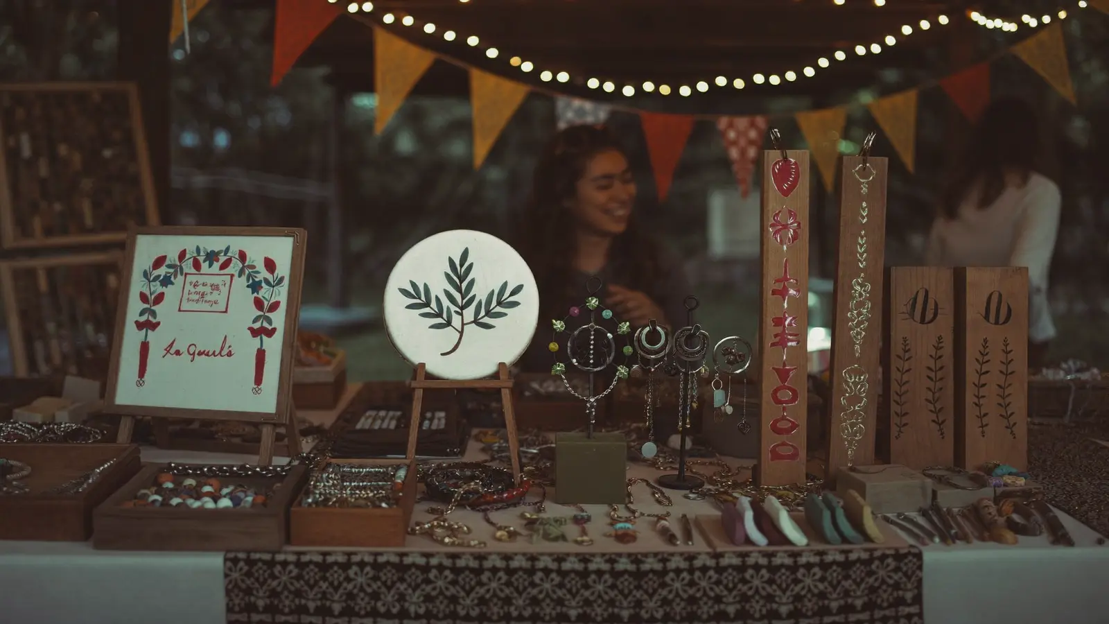 Handmade crafts, jewelry, and textiles for sale at a festival marketplace booth